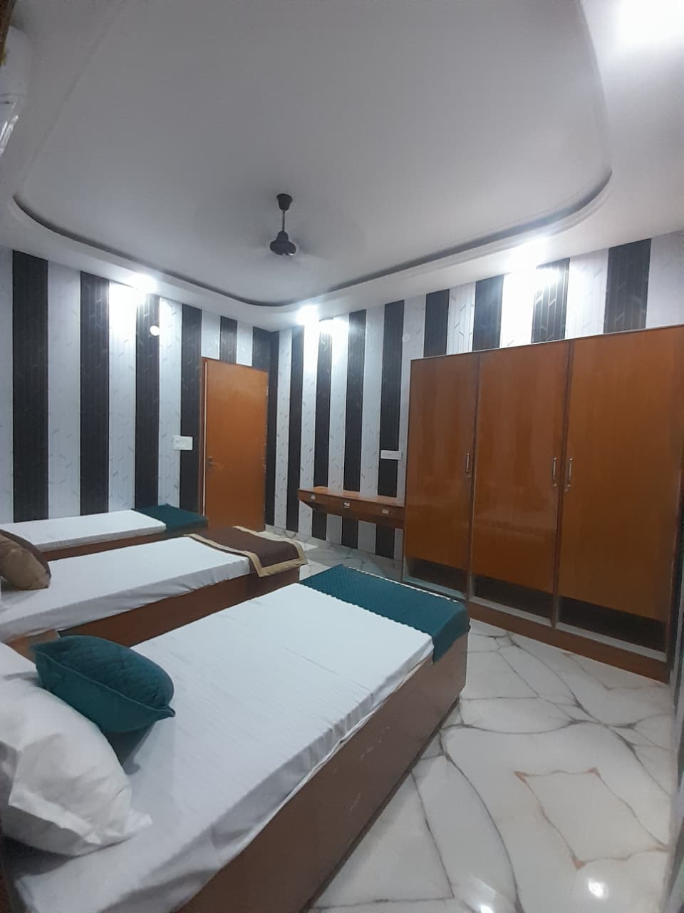 Spacious double bedroom at Shree Shyam hostels with comfortable bedding and modern furnishings